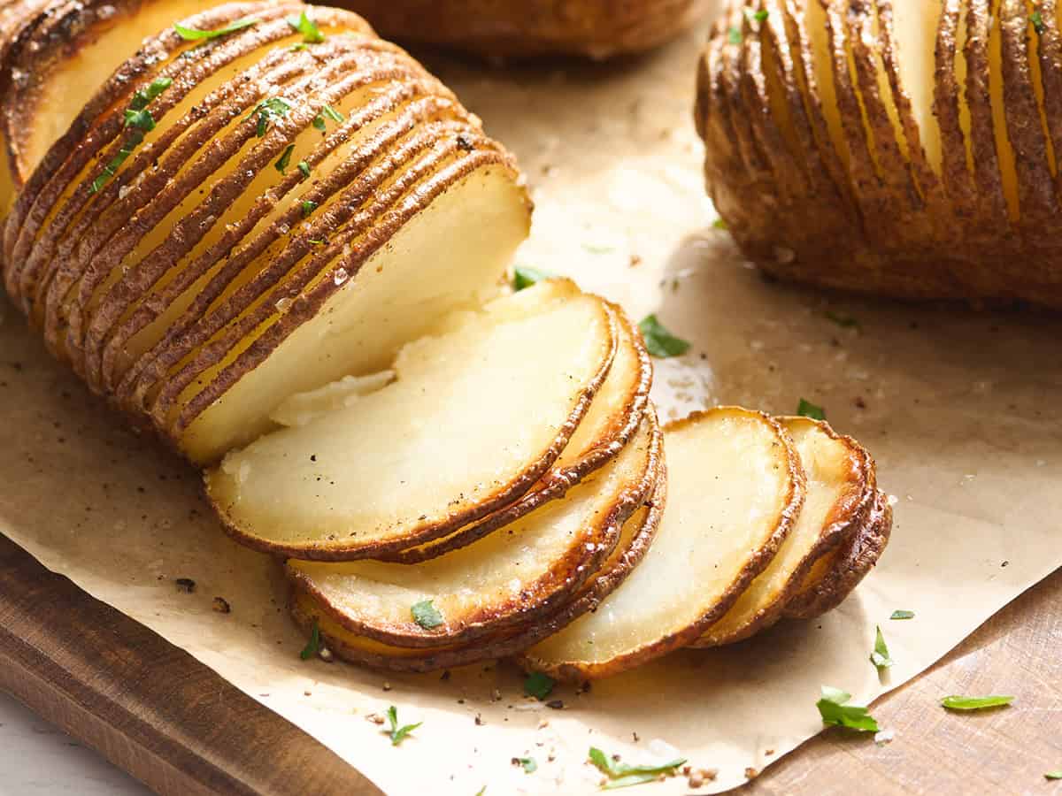 Side view of a Hasselback potato with the slices separated.