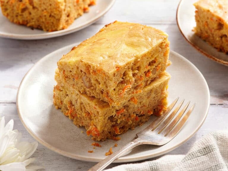 Side view of carrot cake bars on a plate.