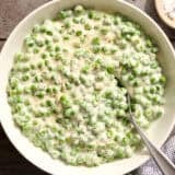 Overhead view of a bowl of homemade creamed peas.