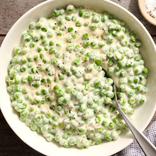 Overhead view of a bowl of homemade creamed peas.
