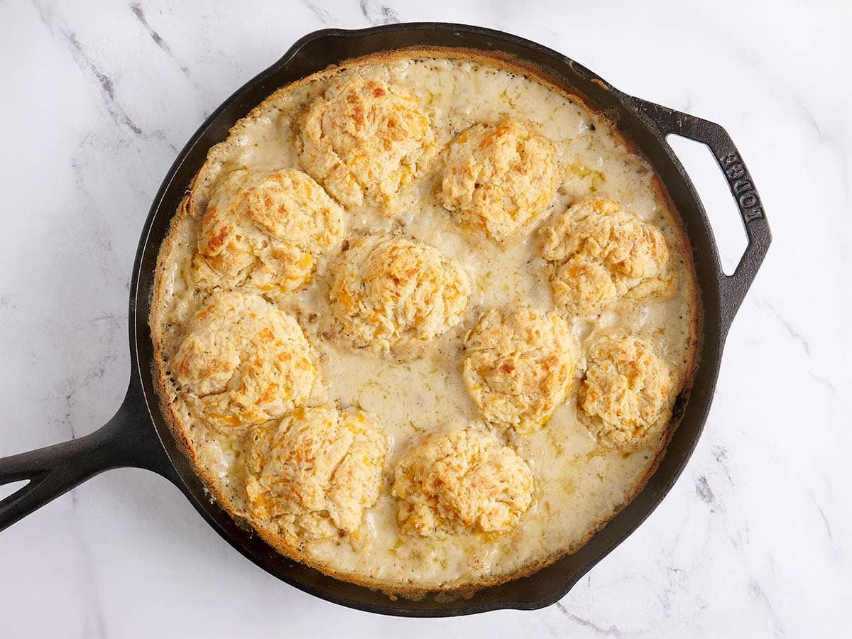 Finished biscuits and gravy bake in a skillet.