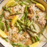 Overhead view of creamy asparagus chicken in a skillet.