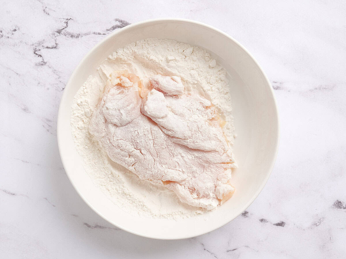Chicken breast dipped in flour.