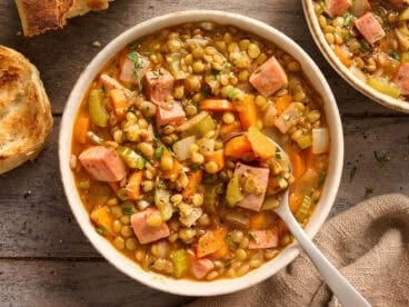 Overhead view of a bowl of lentil and ham soup.