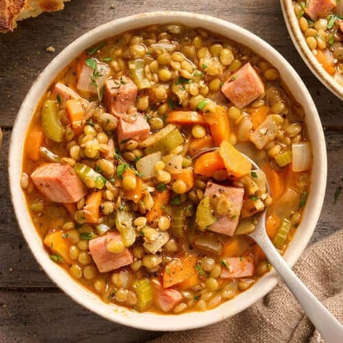 Overhead view of a bowl of lentil and ham soup.
