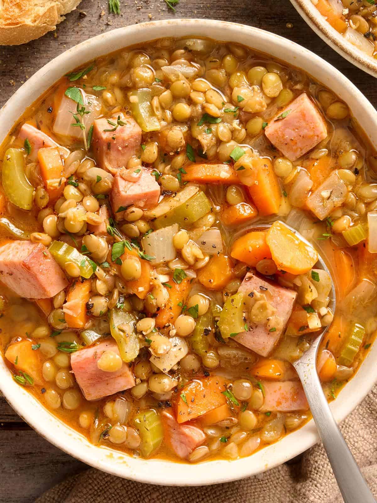 Overhead view of a bowl of lentil and ham soup.