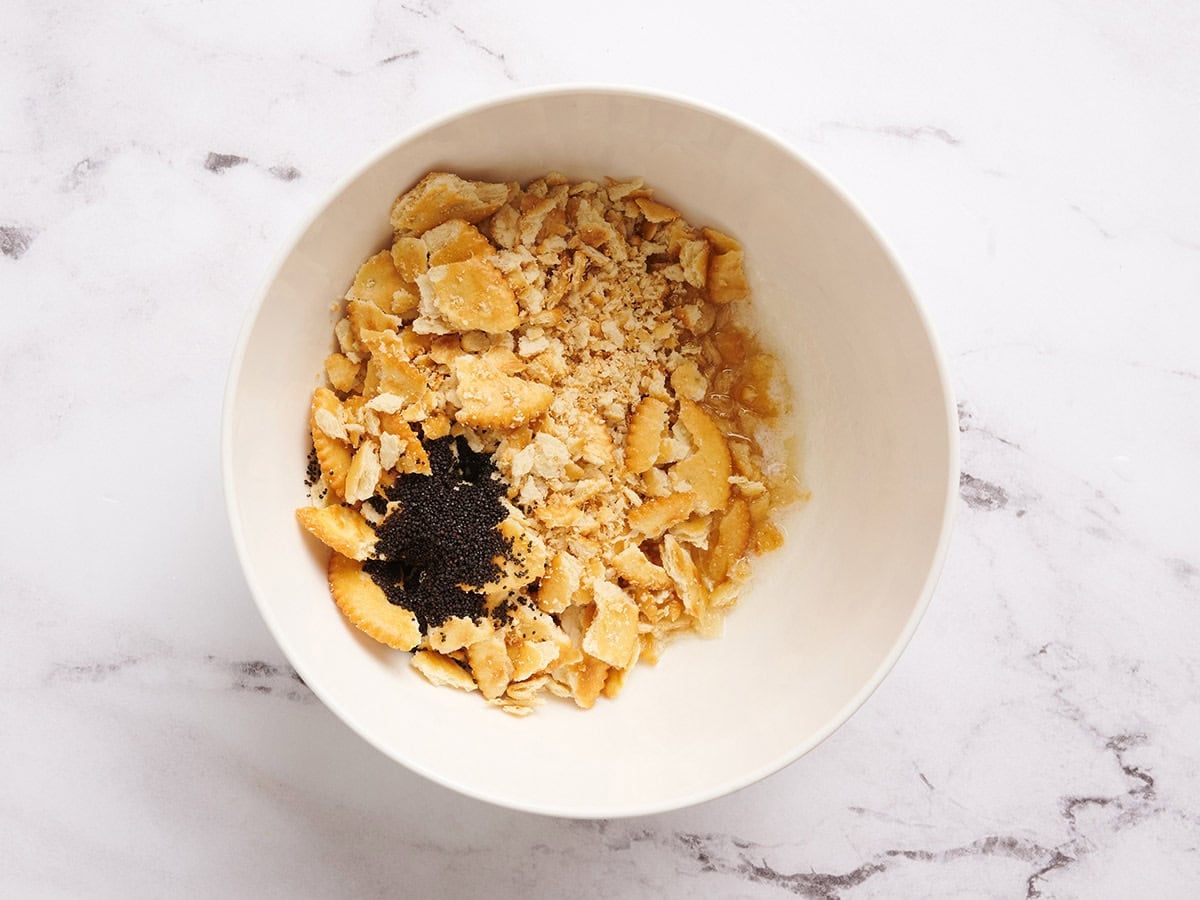 Crushed crackers and poppy seeds in a bowl.