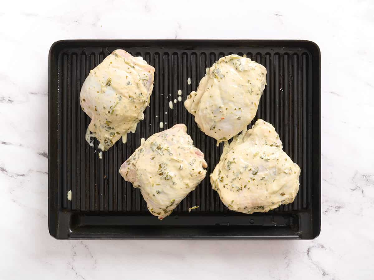 Chimichurri chicken thighs on a grill.