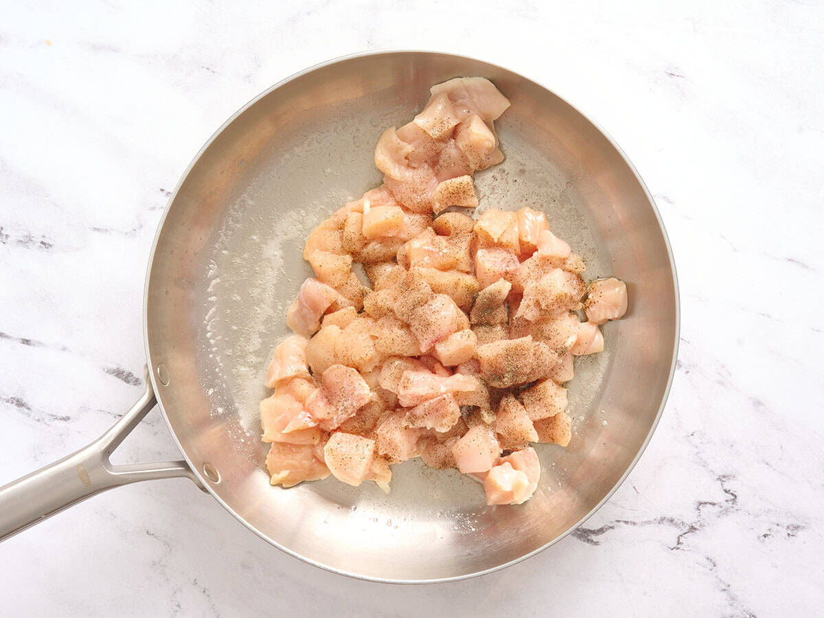 Diced chicken in a skillet.