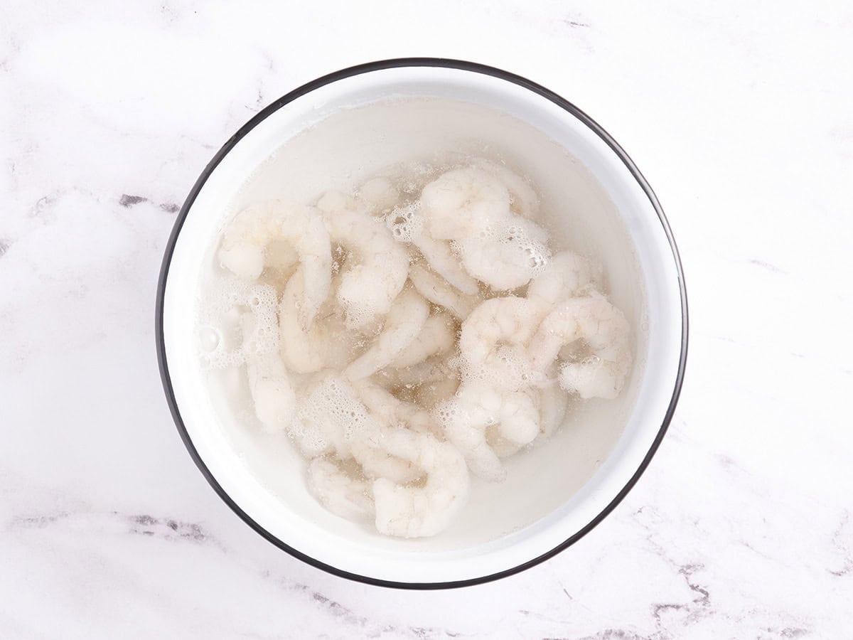 Shrimp defrosting in a bowl.
