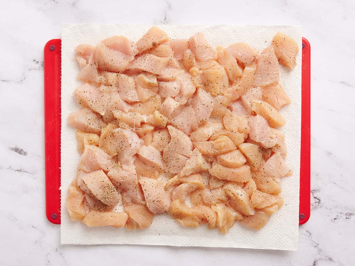 Diced chicken on a cutting mat.