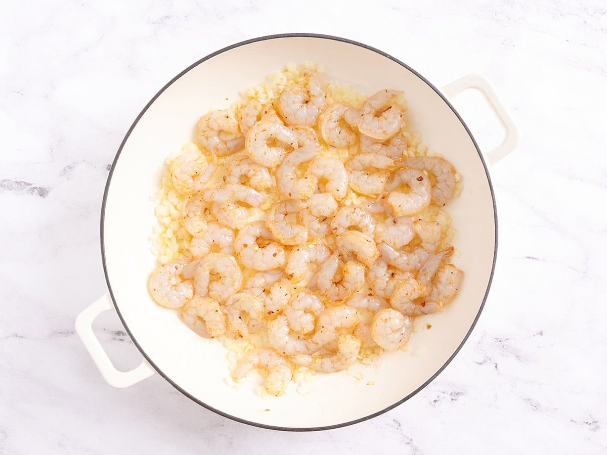 Shrimp cooking in a skillet.