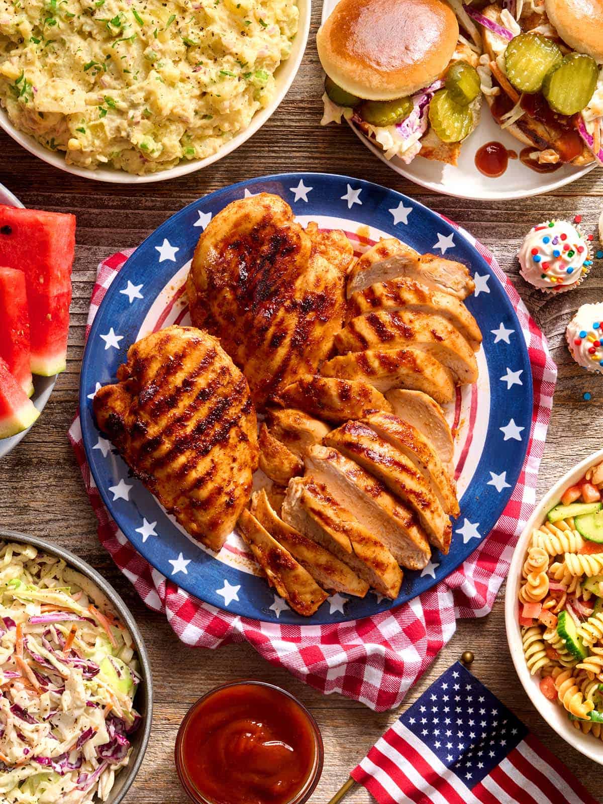 Overhead view of a 4th of July cookout table spread.