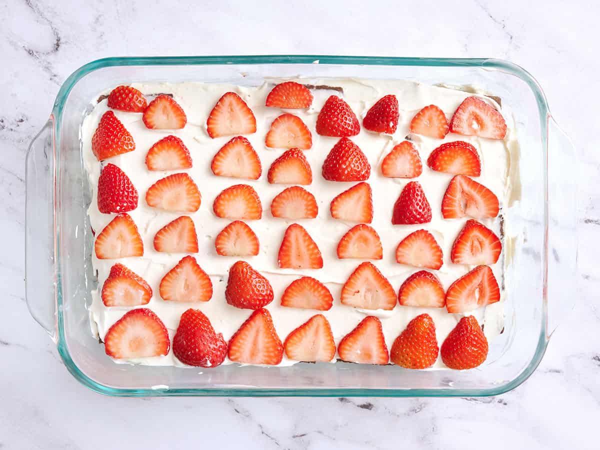 Strawberries layered over a chocolate icebox cake.