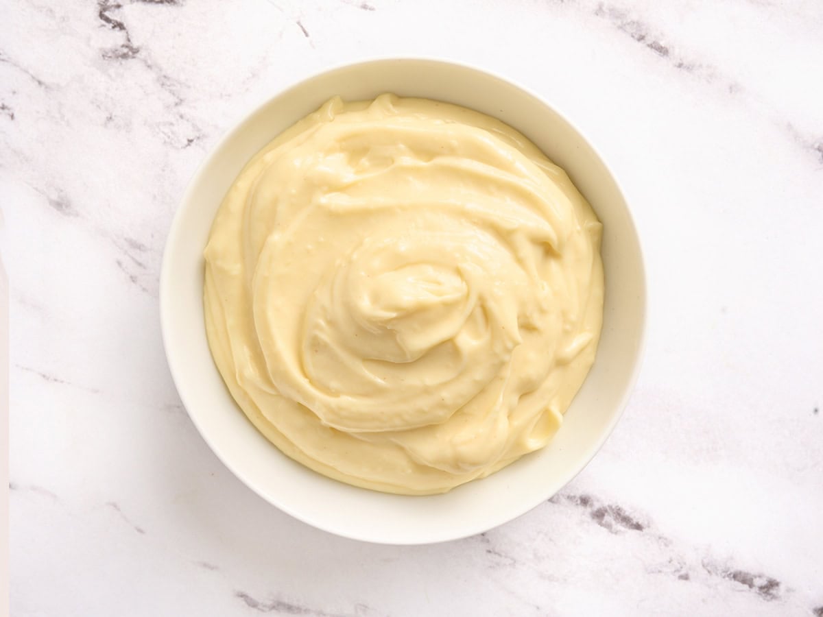 Overhead view of a bowl of homemade garlic aioli.