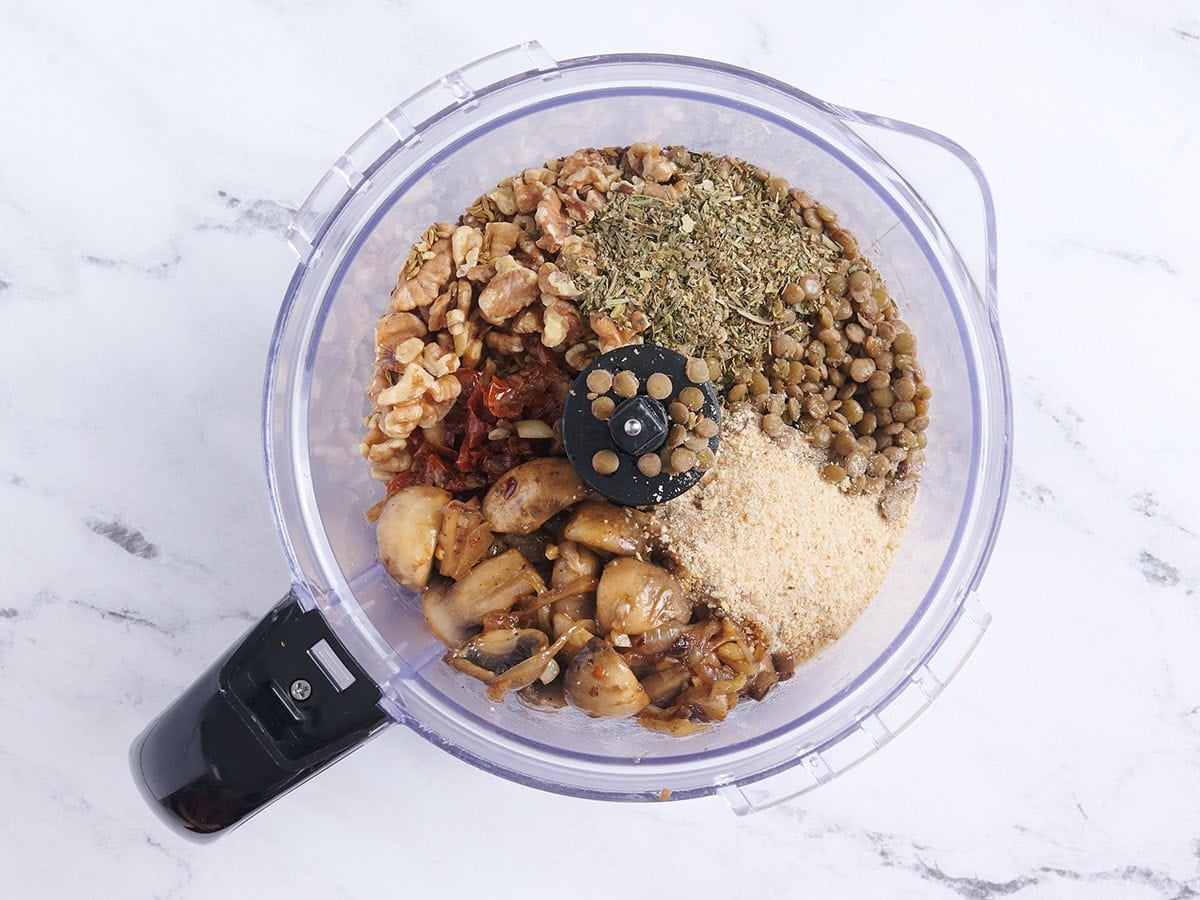The ingredients for vegan meatballs in a food processor.