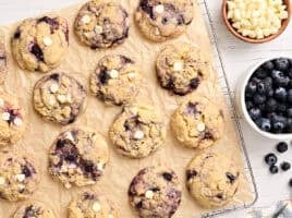Overhead view of blueberry cookies on parchment paper.