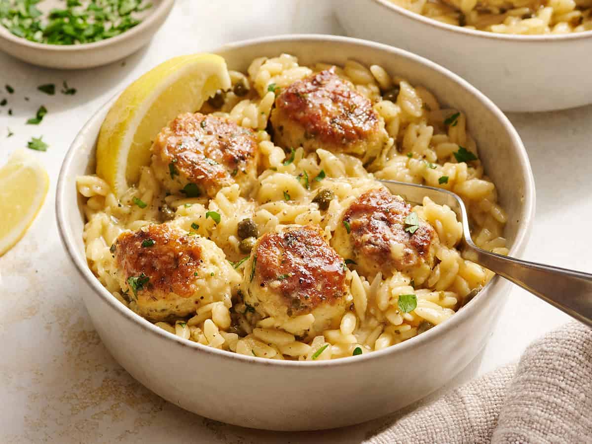 Chicken piccata meatballs and orzo in a bowl.