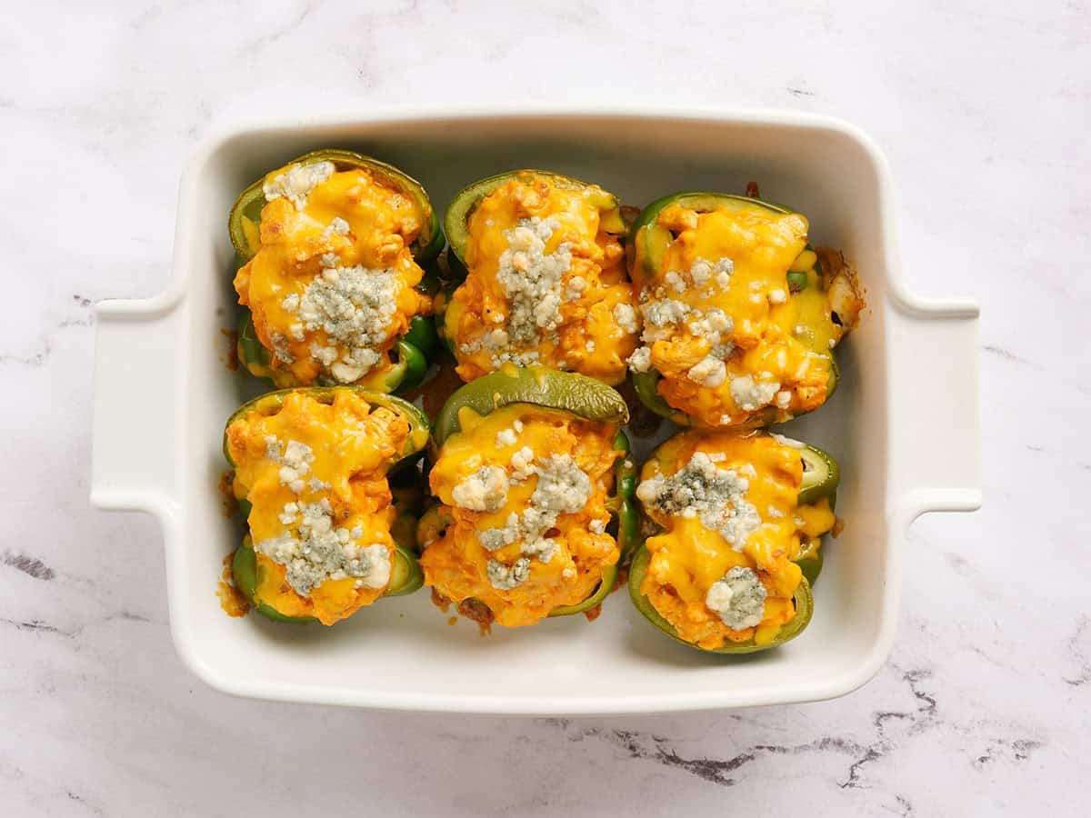 Buffalo chicken stuffed peppers topped with green onions.
