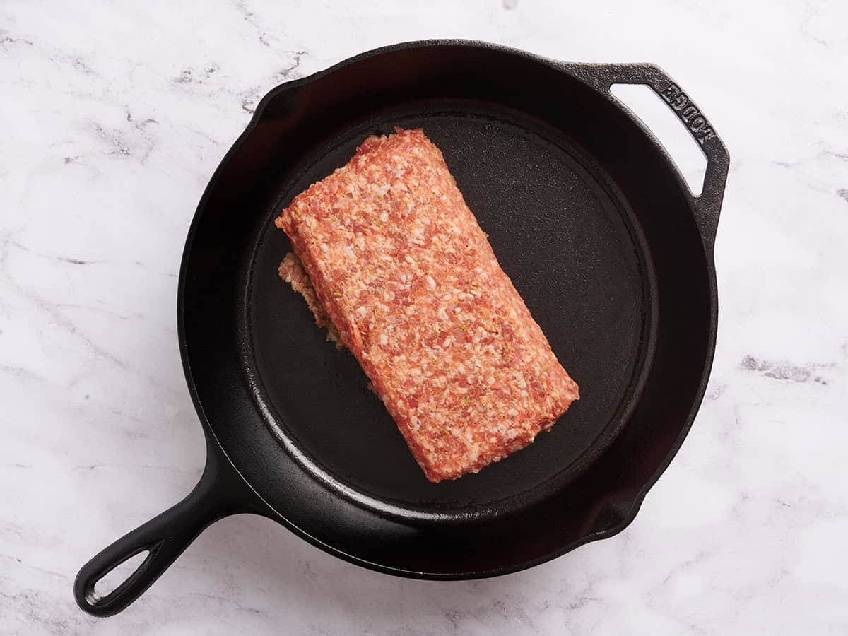 Ground sausage in a skillet.