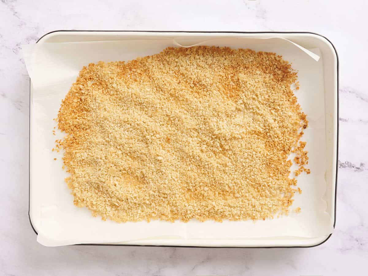 Toasted breadcrumbs on a baking sheet.