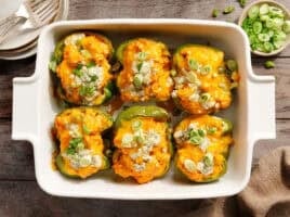 Overhead view of creamy buffalo chicken stuffed peppers in a baking dish.