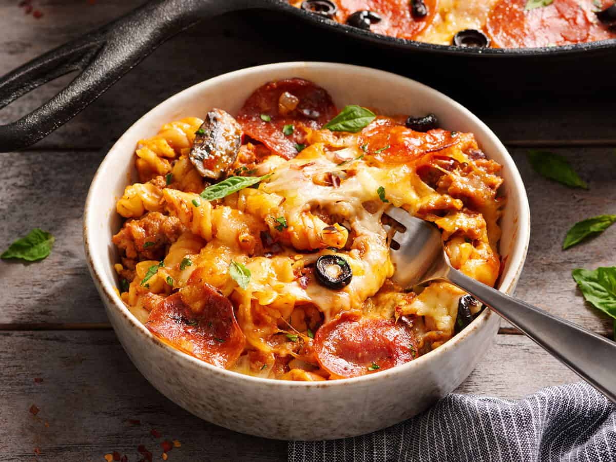 Front side view of pizza casserole in a bowl.
