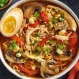 Overhead view of a bowl of slow cooker chicken ramen with a soy marinated egg.