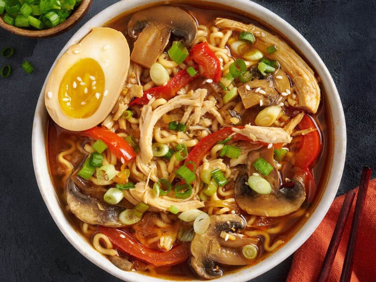 Overhead view of a bowl of slow cooker chicken ramen with a soy marinated egg.