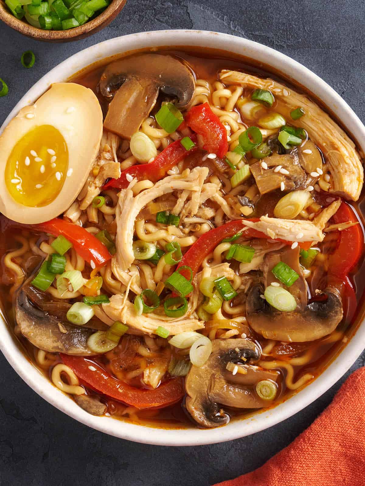 Overhead view of a bowl of slow cooker chicken ramen with a soy marinated egg.