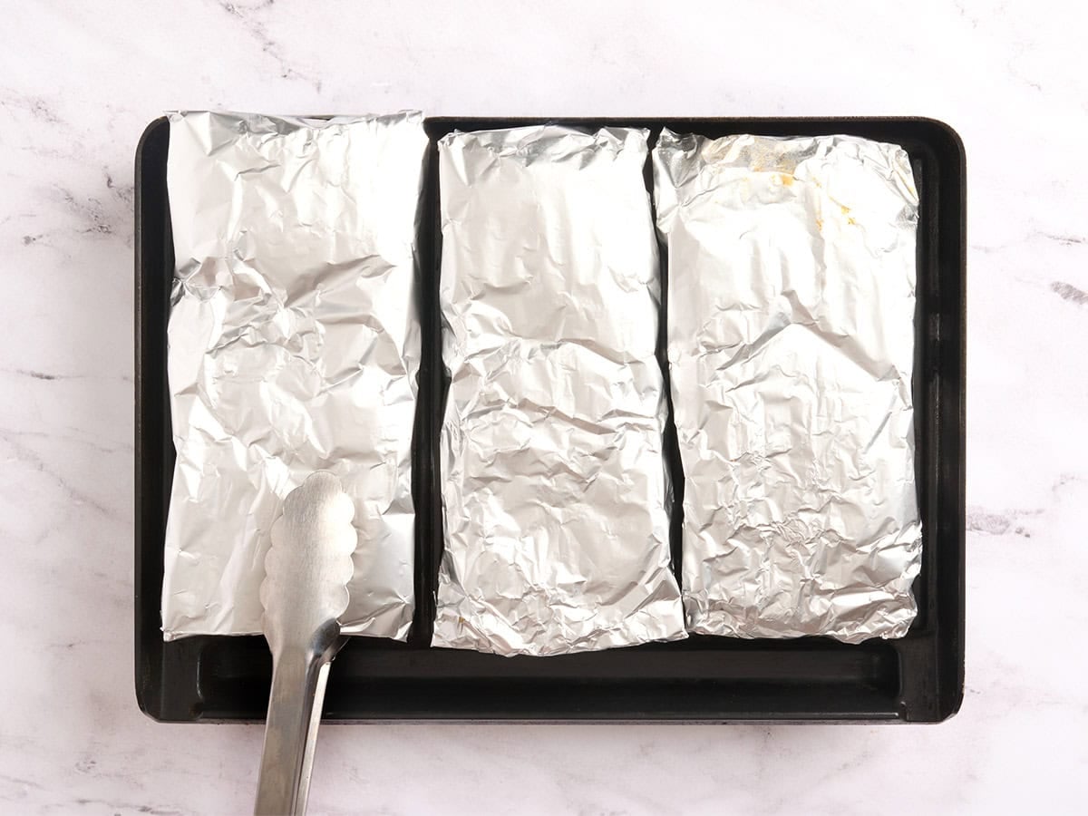 BBQ chicken packets on a grill.