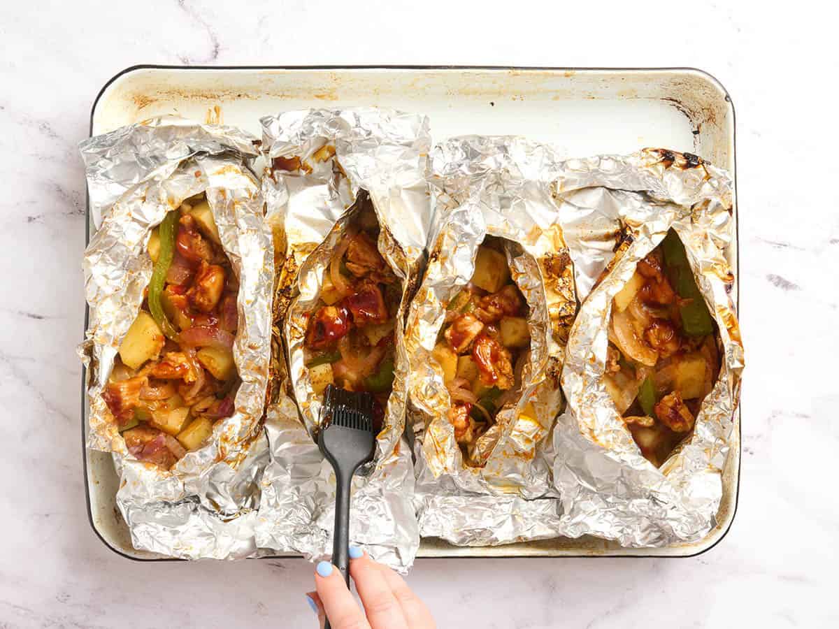 Finished BBQ chicken foil packets after grilling.