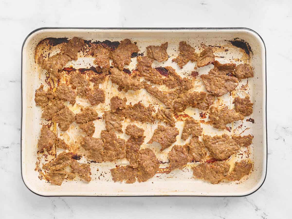 Sheet pan doner kebab meat on a sheet pan after broiling.