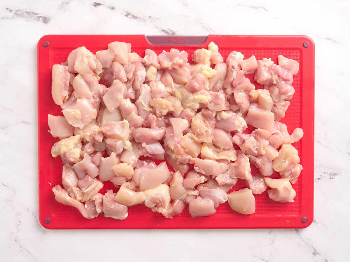 Diced chicken breast on a cutting board.