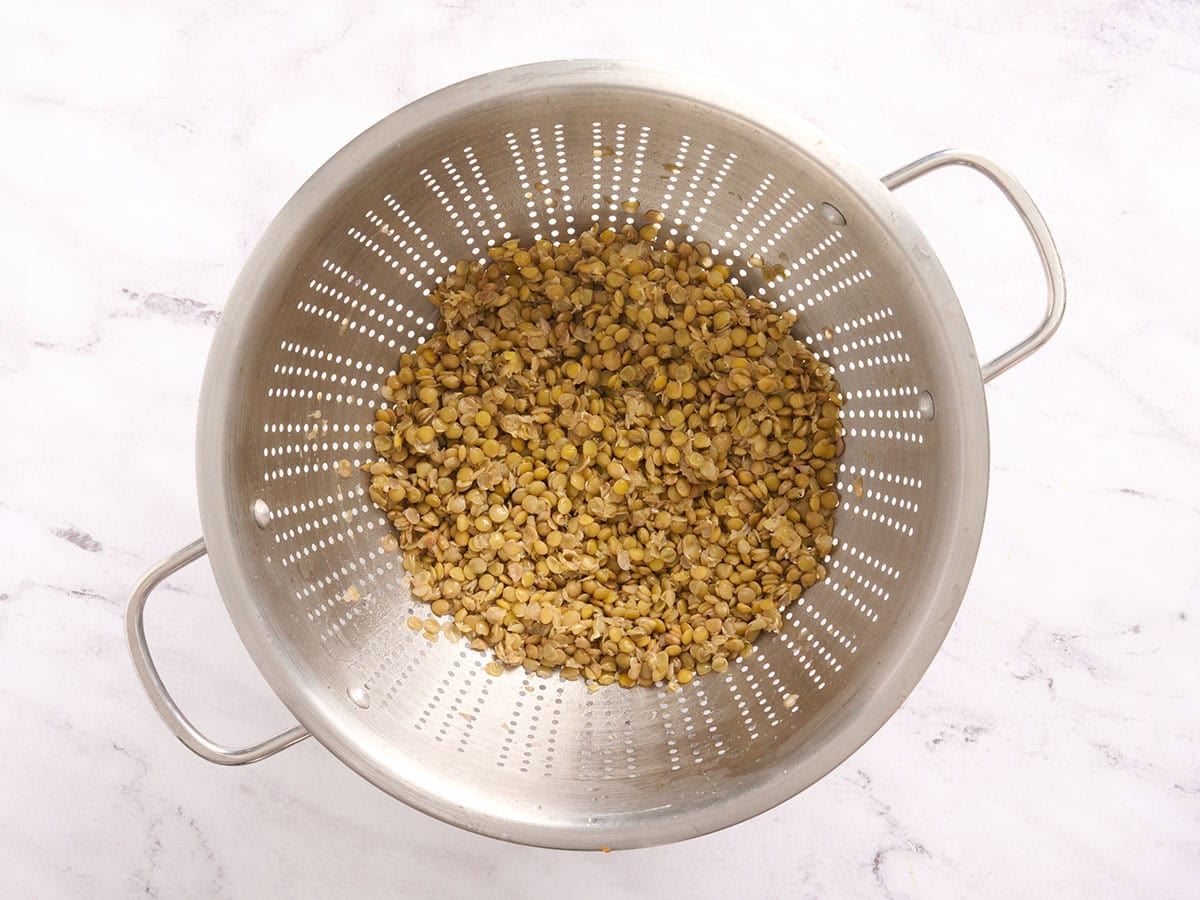 Cooked lentils in a colander.