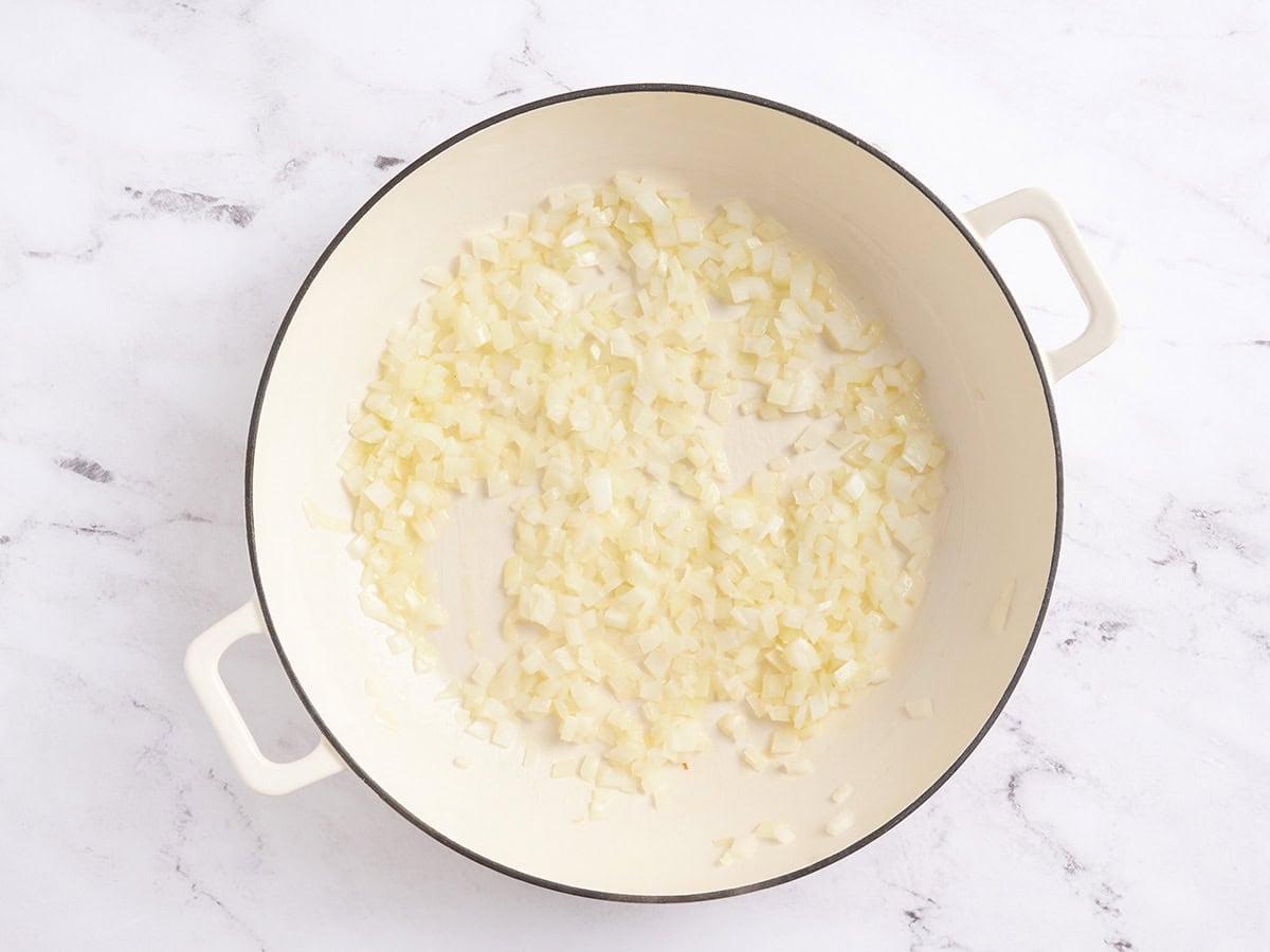 Melted butter and diced onions in a skillet.