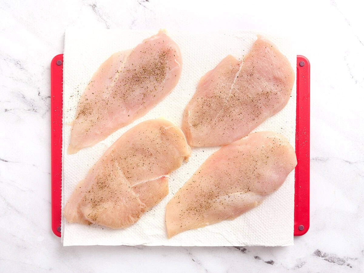 Chicken filets seasoned with salt and pepper.