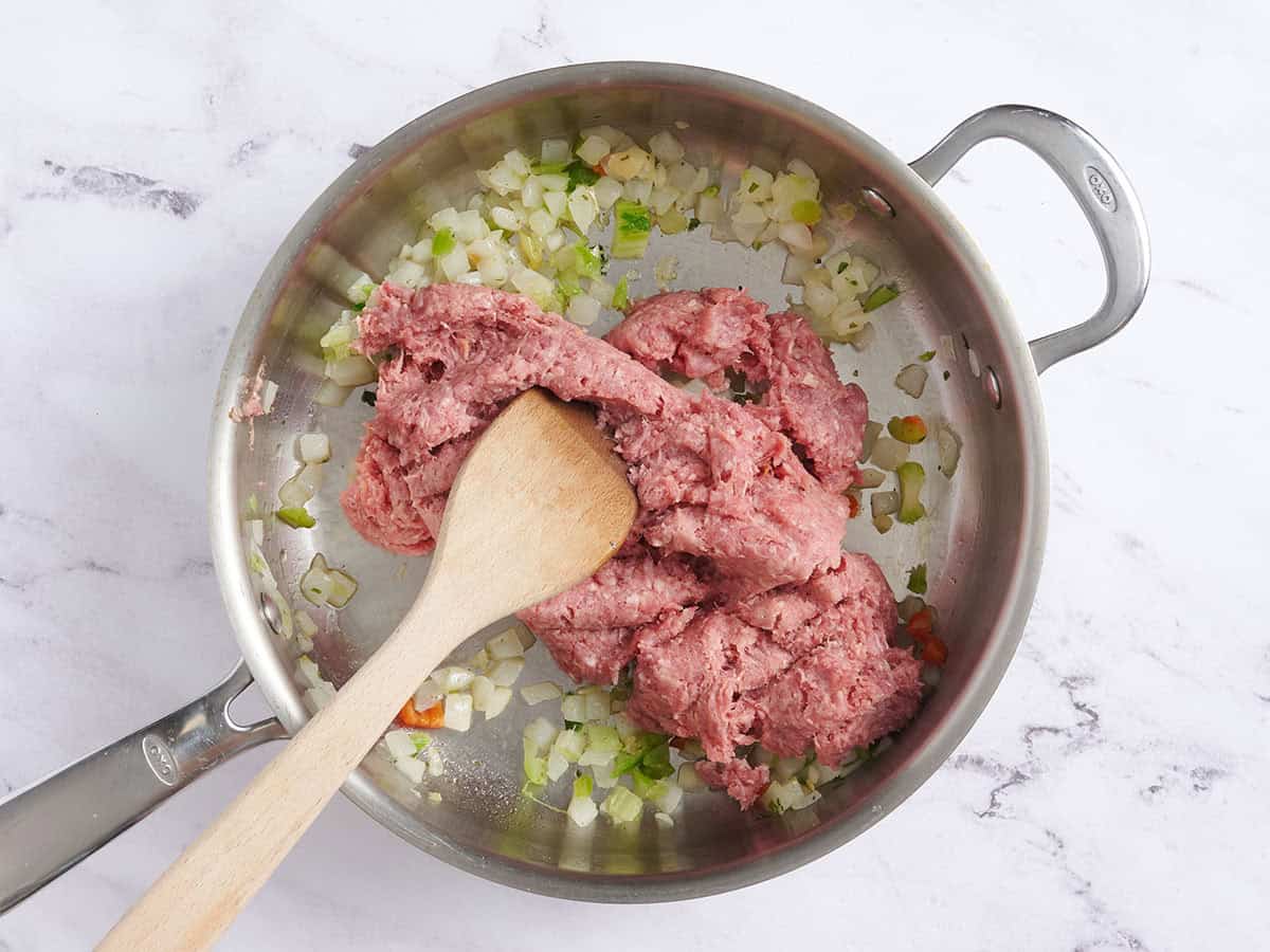 Ground beef and sausage added to sauteed peppers and onions.