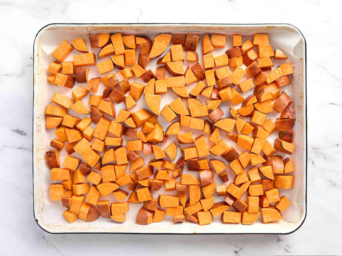 Diced sweet potatoes on a sheet pan.
