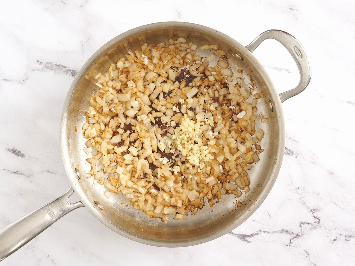 Sauteed onions in a skillet.