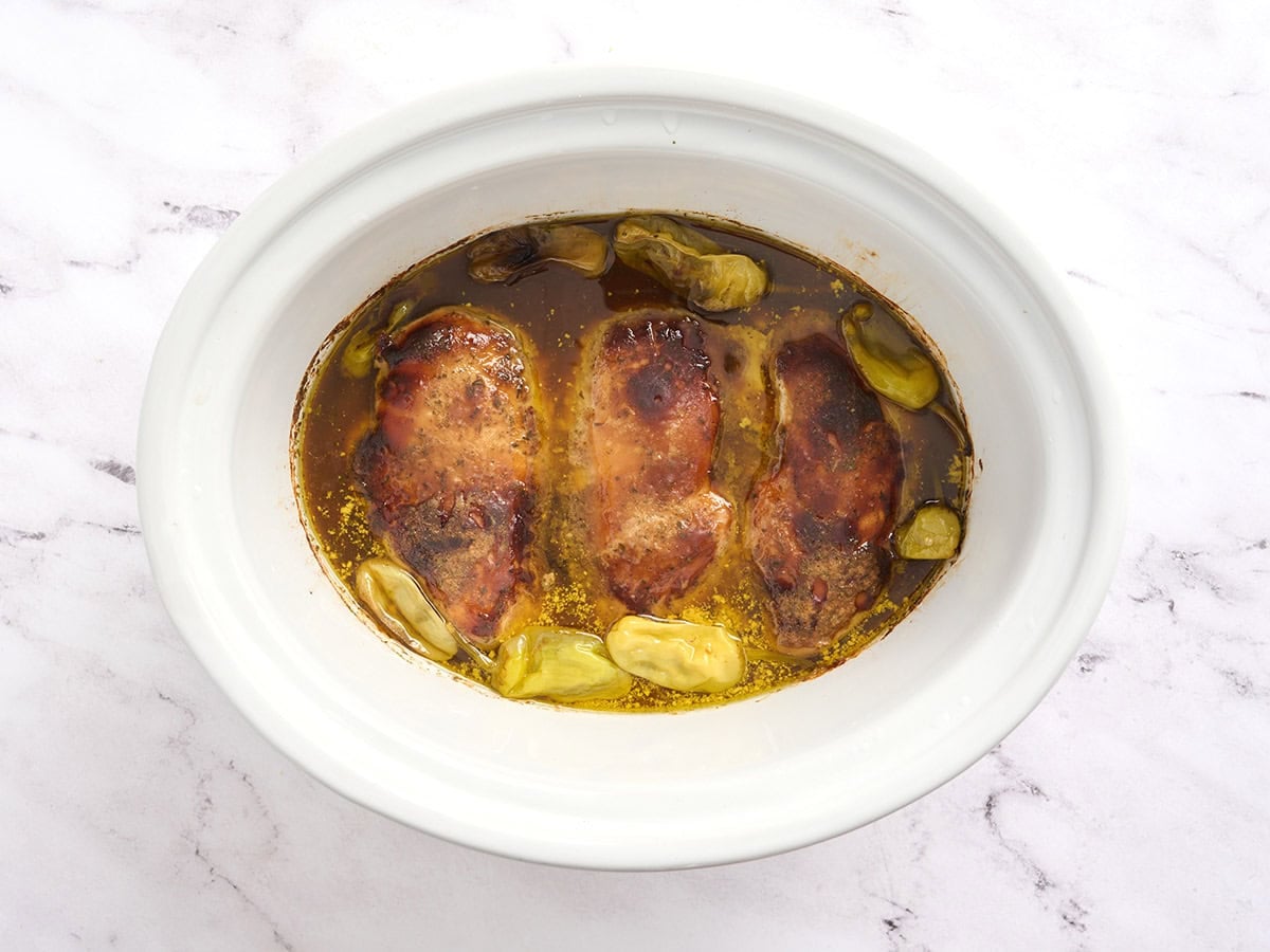 Mississippi chicken in a slow cooker after cooking on high.