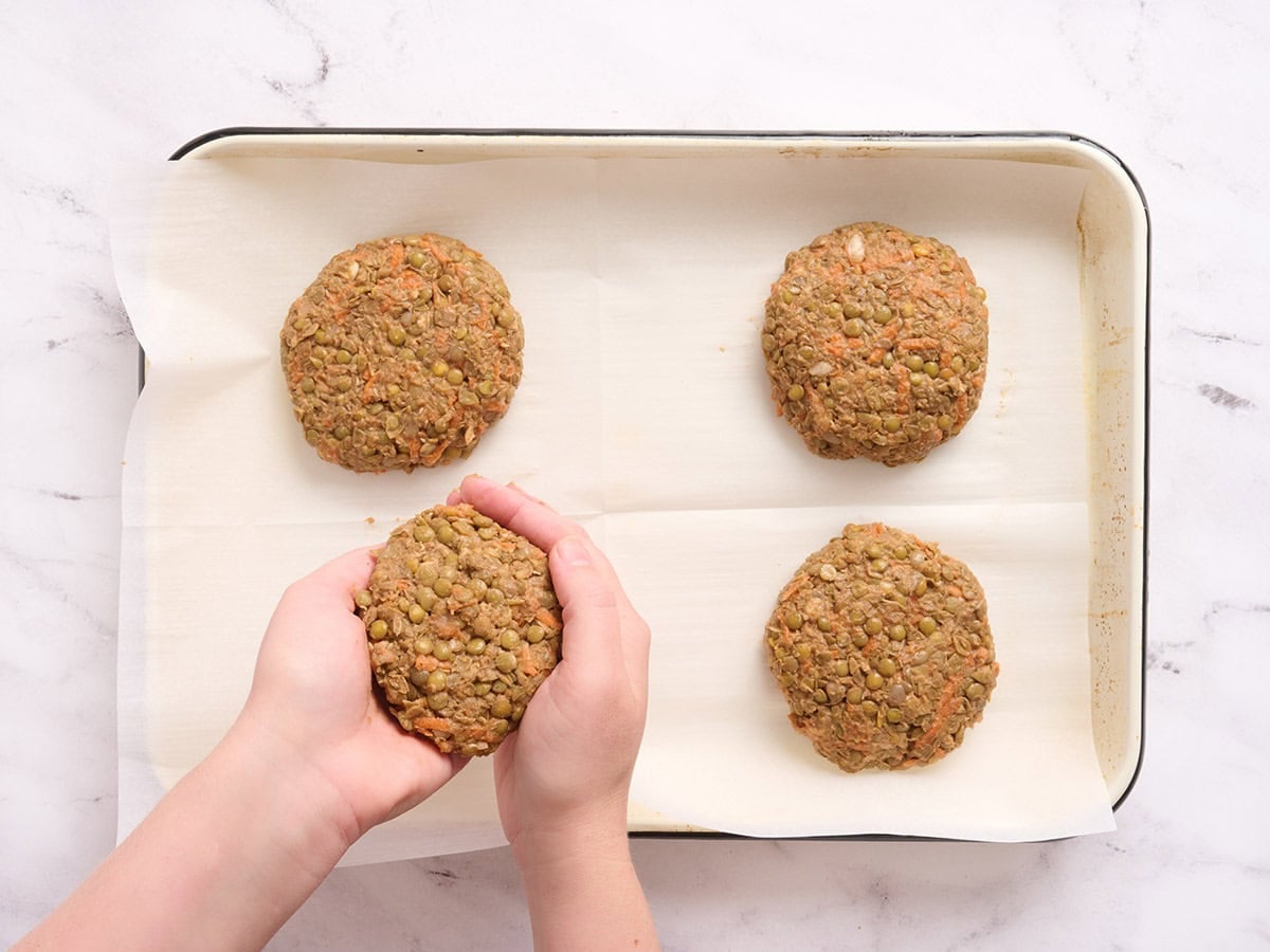 Lentil burger mixture being formed into four patties.