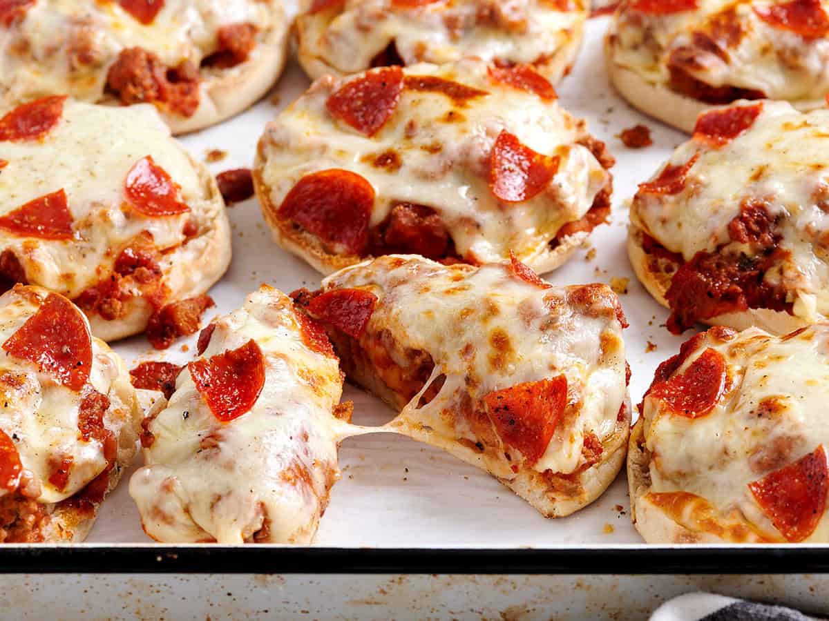 Side view of pizza burgers, with one cut in half.