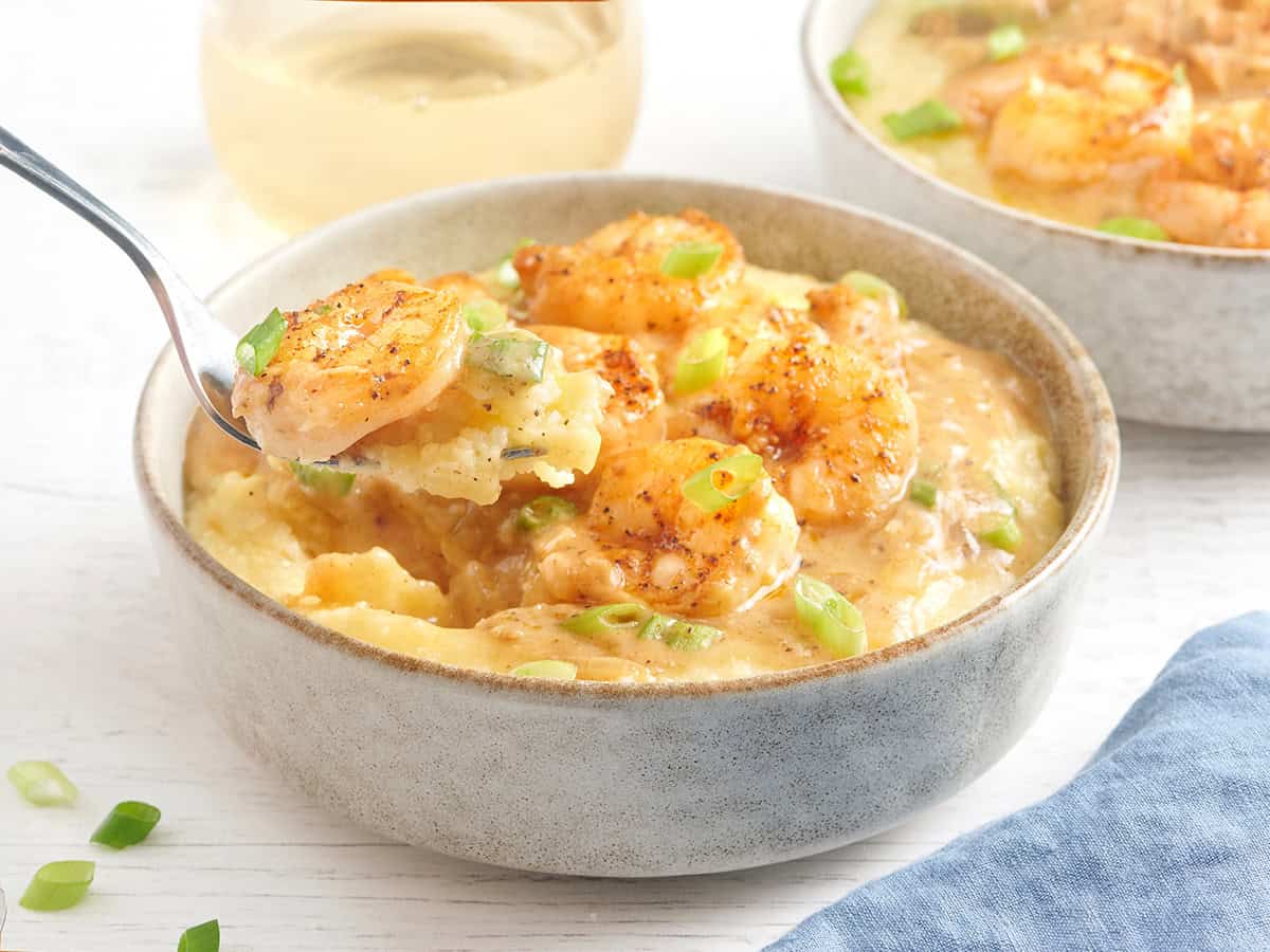 Side view of a bowl of shrimp and grits.