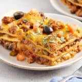 Sided view of a slice of taco casserole on a plate.