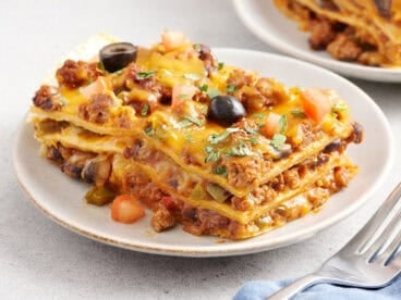 Sided view of a slice of taco casserole on a plate.
