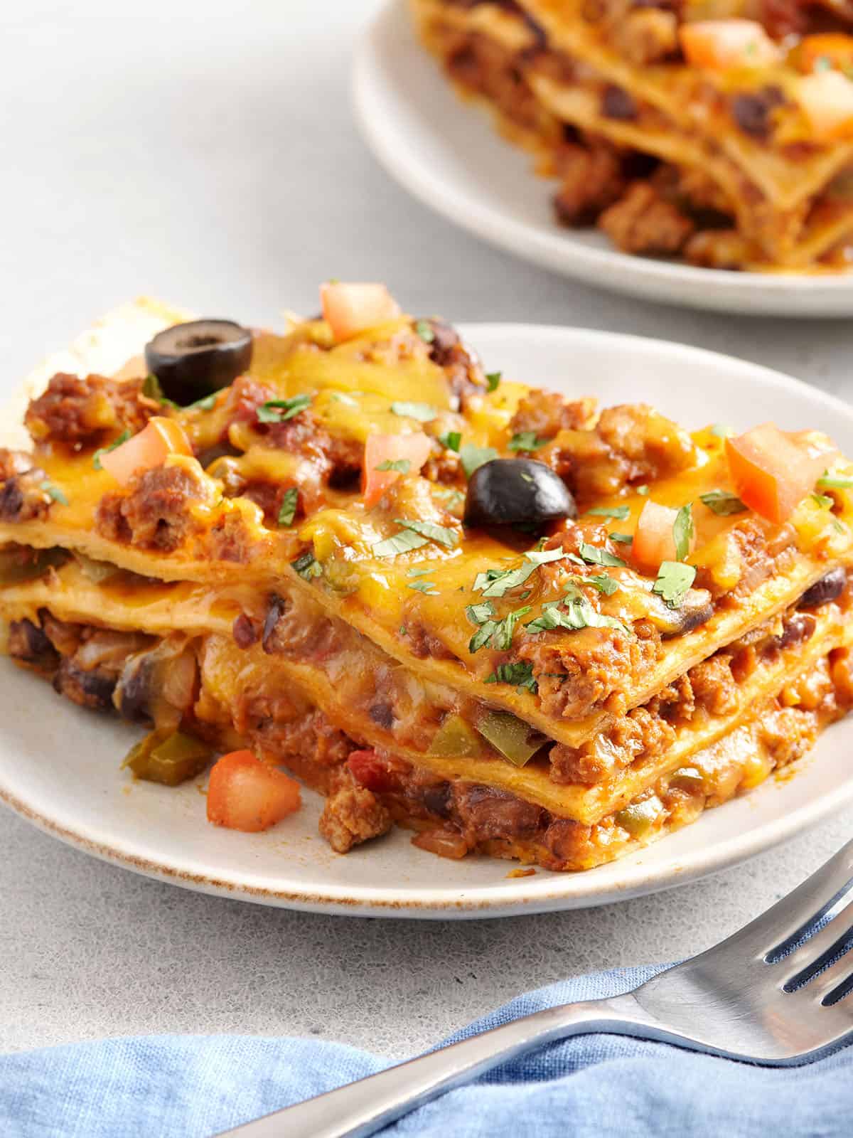 Sided view of a slice of taco casserole on a plate.
