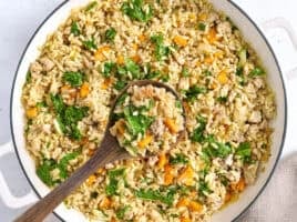 Overhead view of a sweet potato and ground turkey skillet with a wooden spoon.