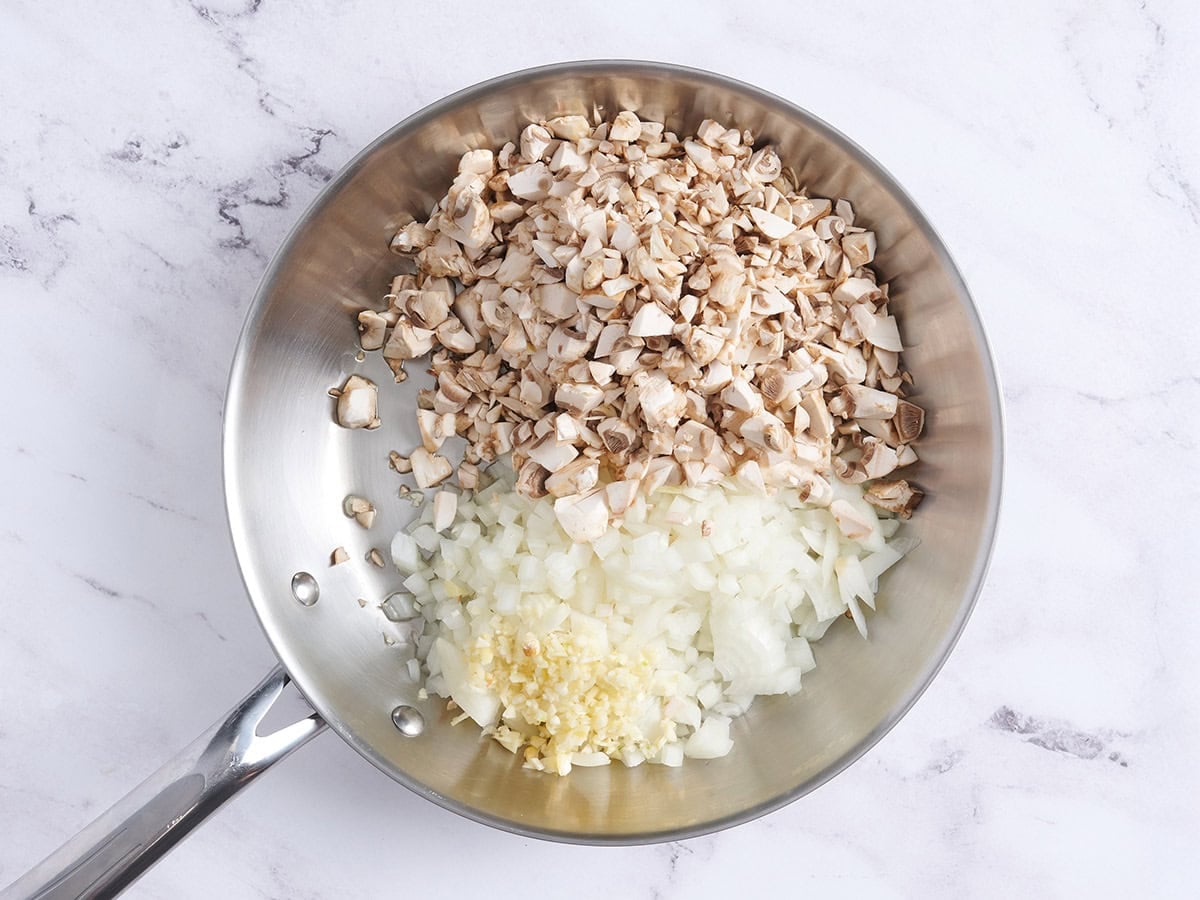 Diced onions, mushrooms and minced garlic in a skillet.