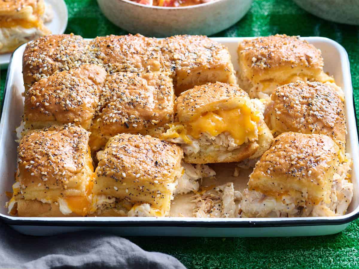 Side view of a platter of chicken sliders.